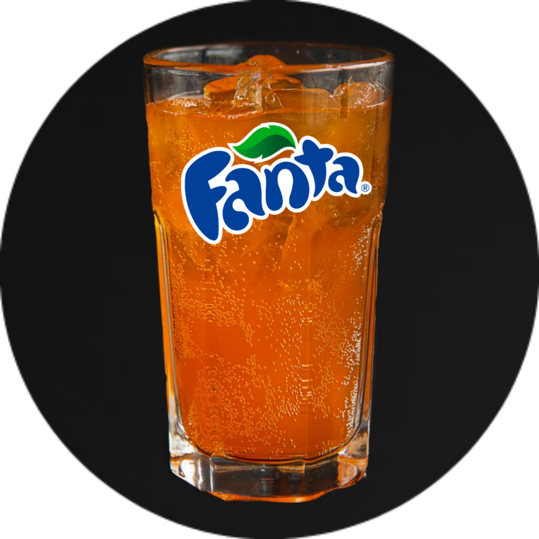 A glass of orange juice with the fanta logo on it.