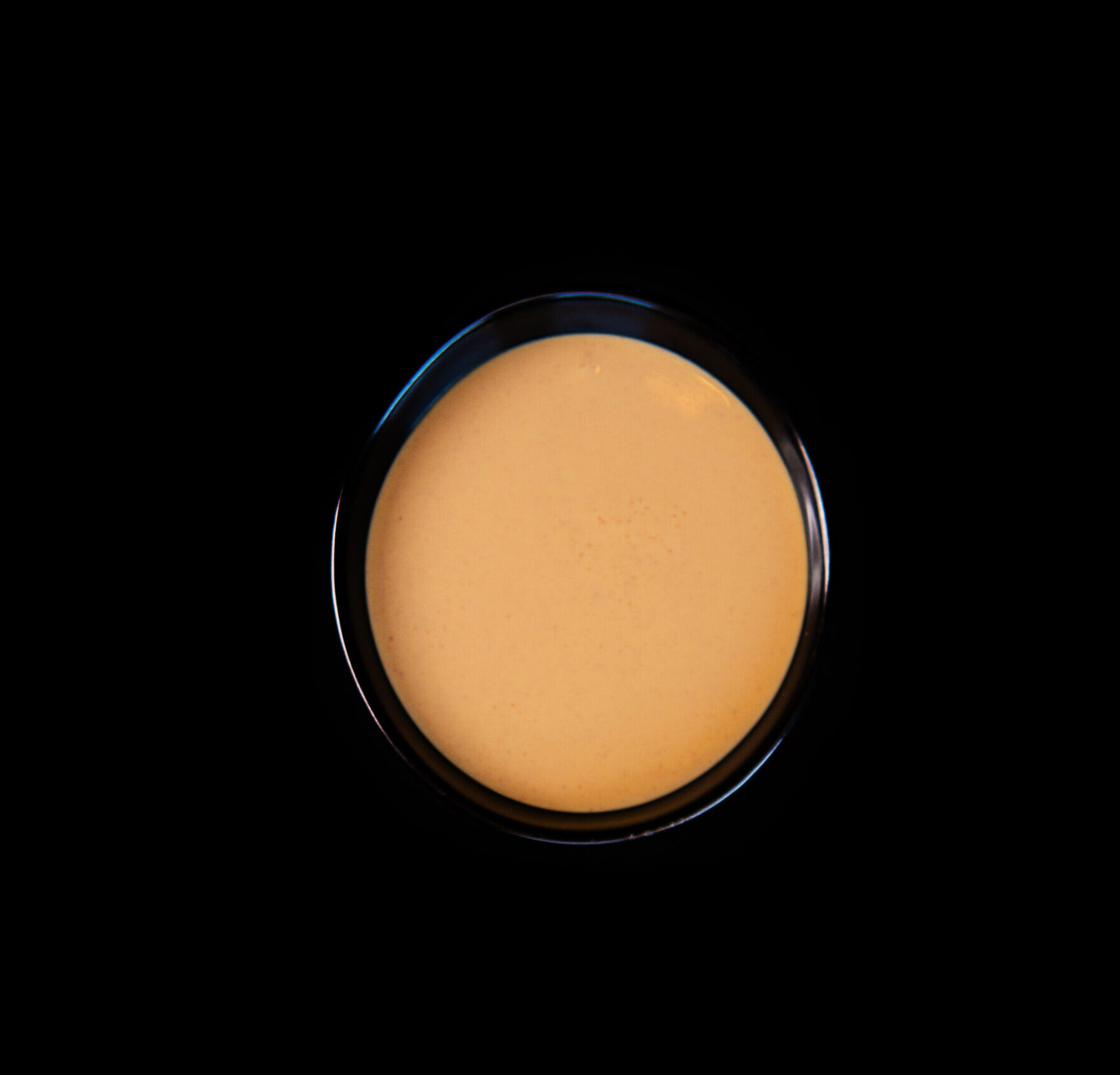 A black background with an orange circle in the middle.