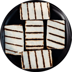 A plate of cookies with white icing on top.