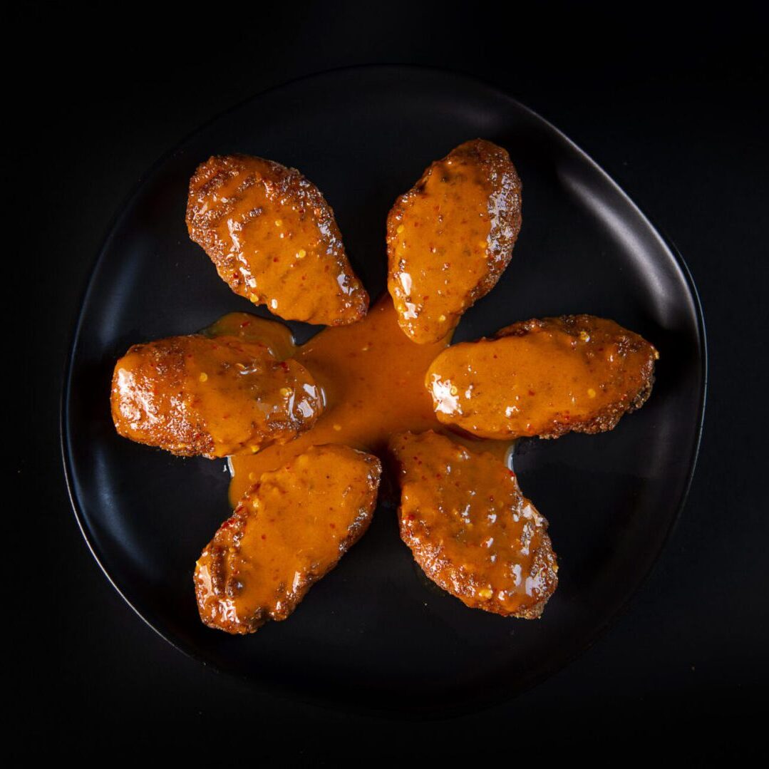 A plate of food that is shaped like an orange flower.