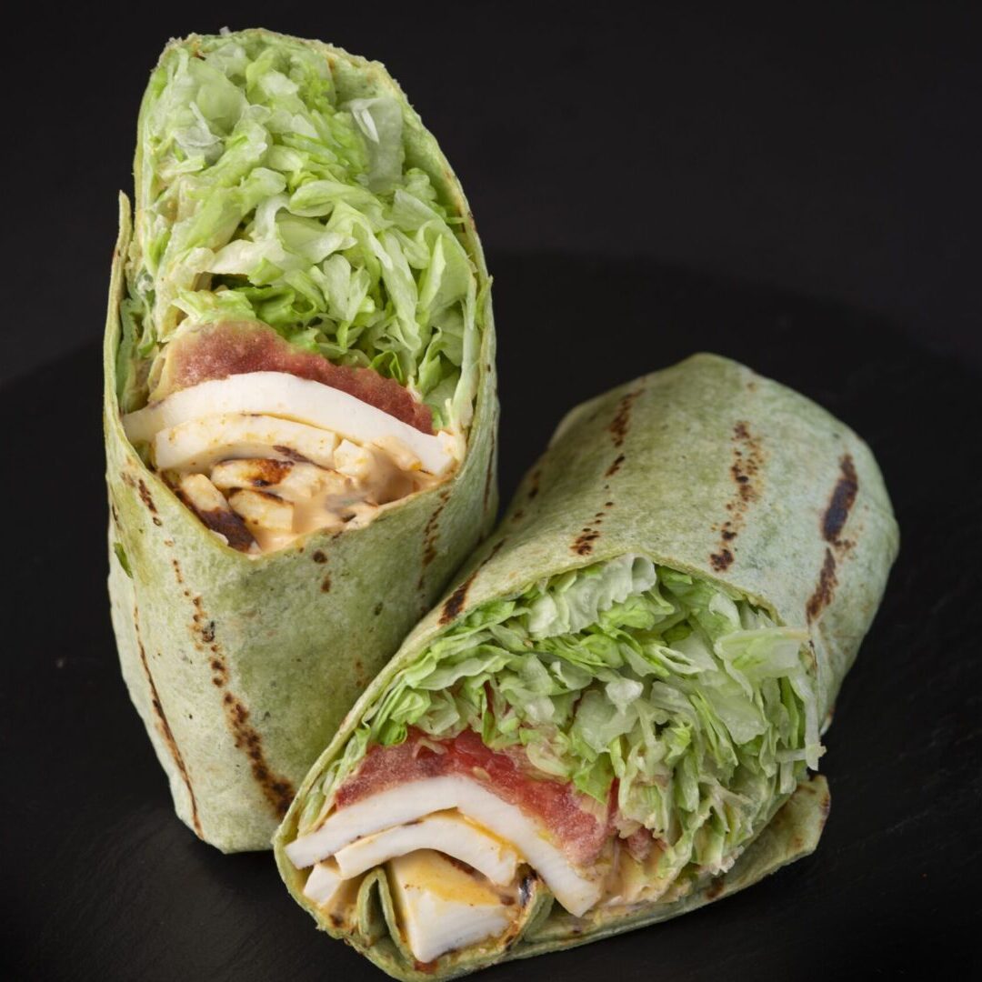 A close up of two wraps on a plate