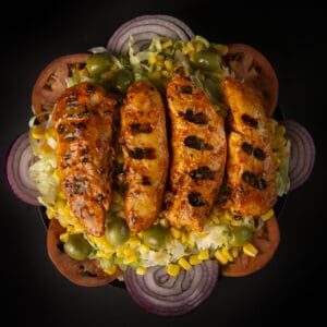 A plate of food with meat, vegetables and rice.